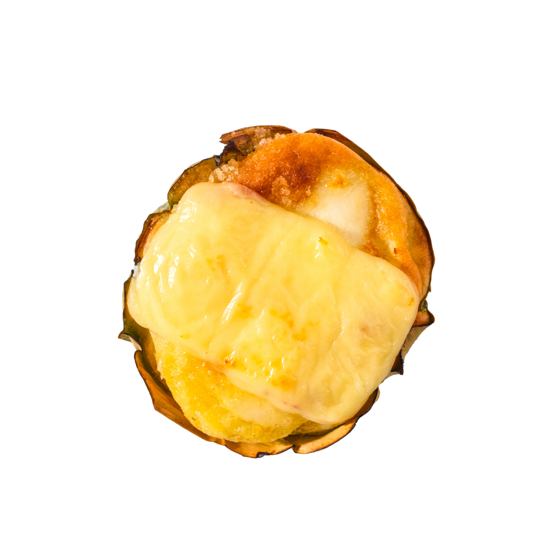 Cheese Max Bibingka topped with melted cheese, showcasing golden-brown edges and creamy yellow melted topping viewed from above